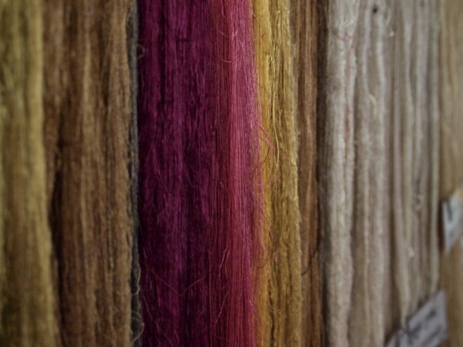Silk in Cambodia, 2015.  A series of hanging raw silk in various natural dyes, Yellows, pinks creams. 